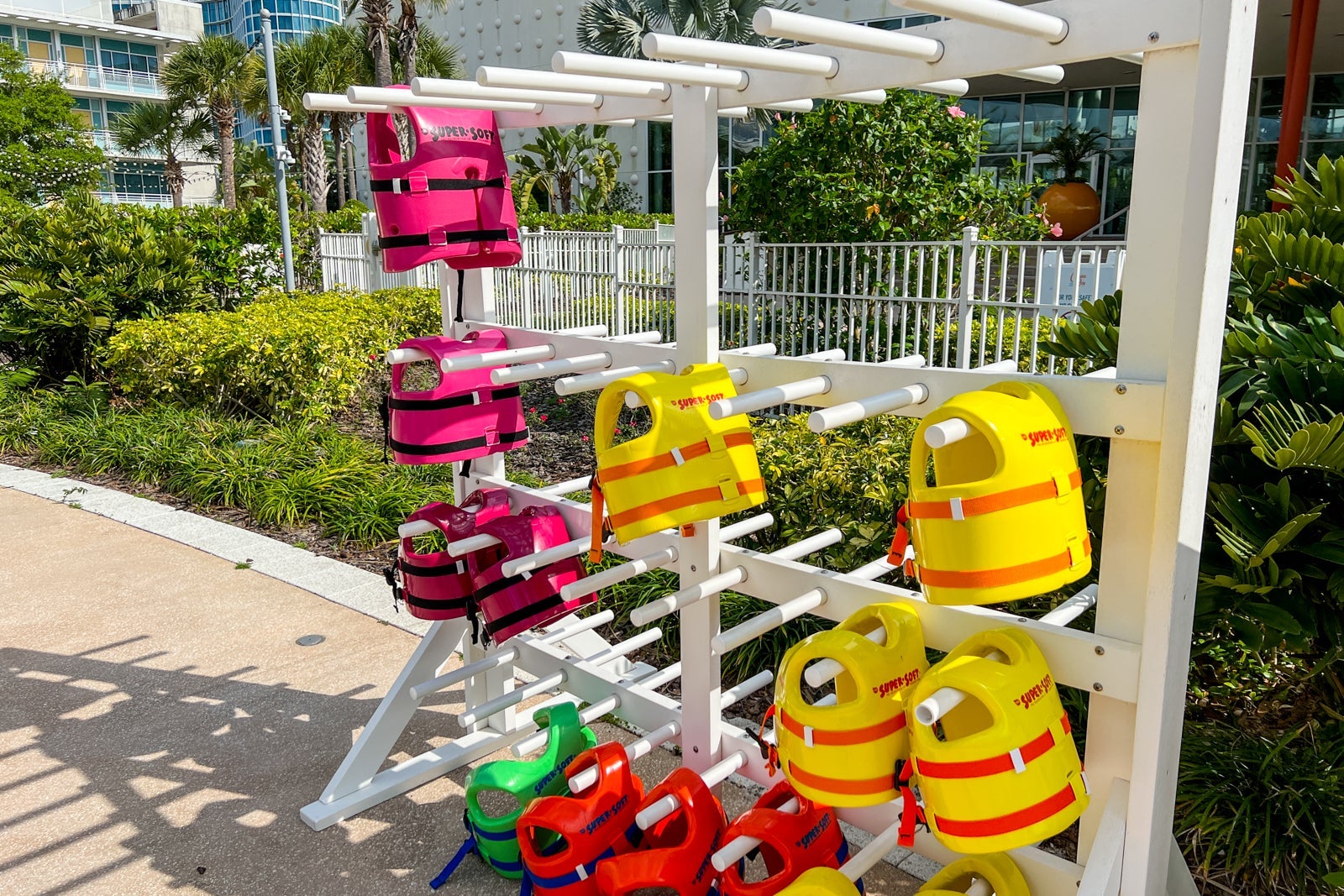 A row of kids' life jackets at the pool.
