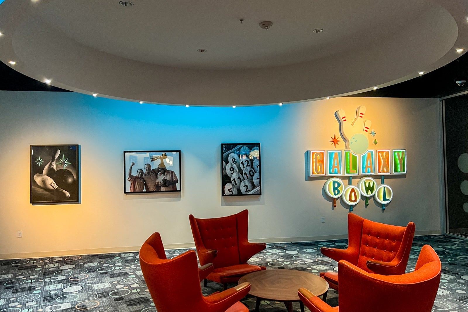 Chairs and a sign inside the bowling alley.