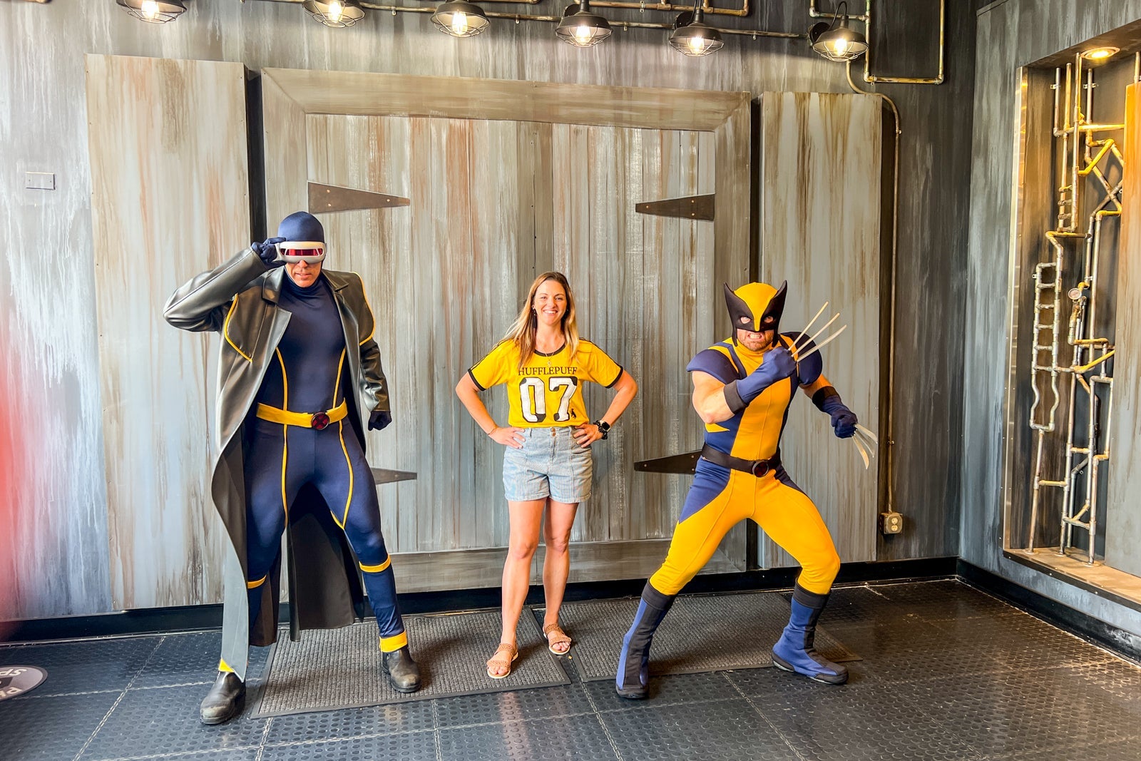 Guest posing with Marvel heroes at Universal Orlando