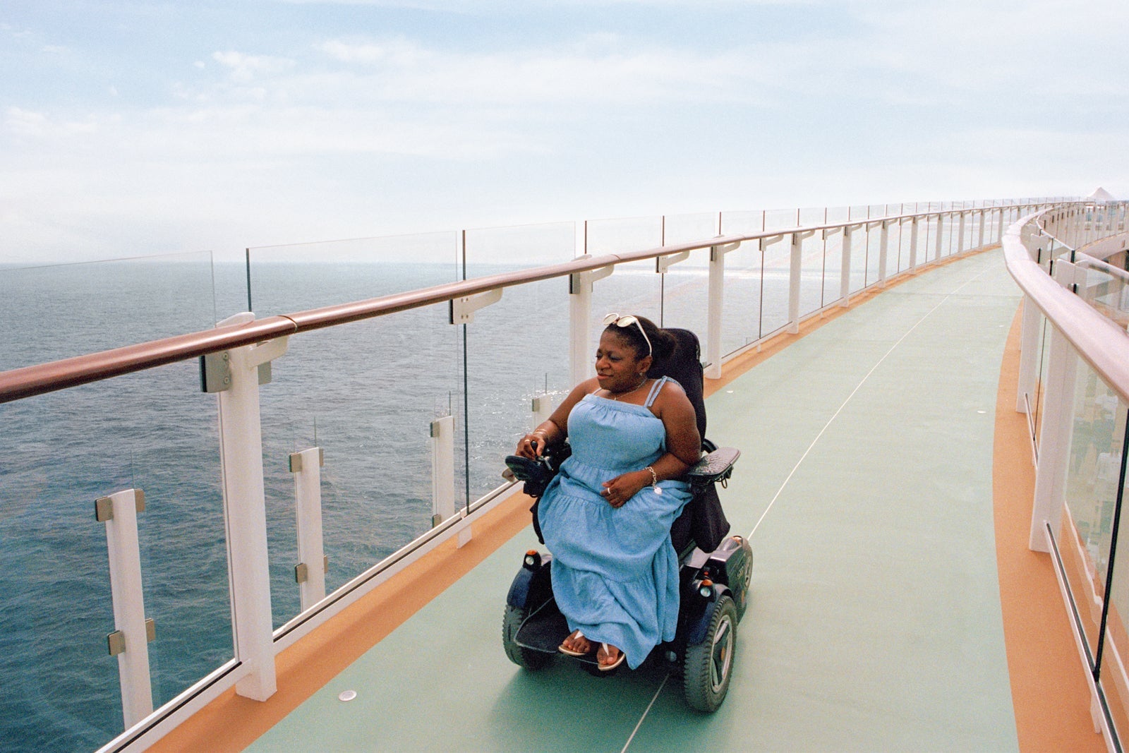 Woman in wheelchair on deck of cruise ship