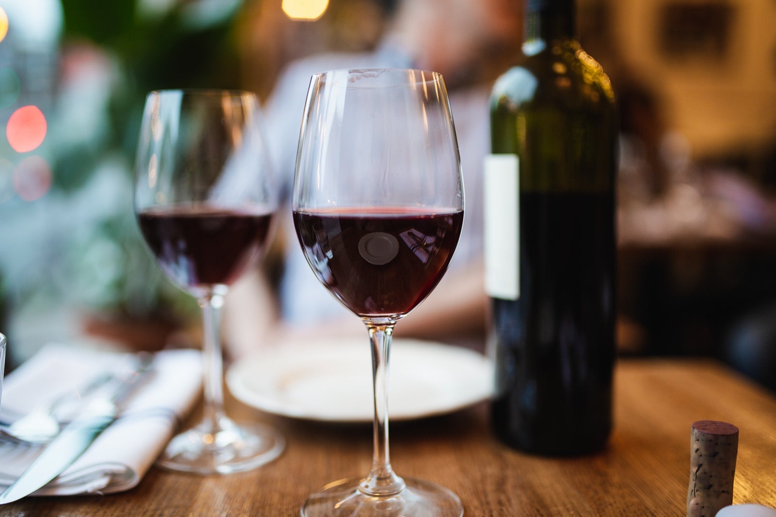 Two glasses of red wine on a dinner table