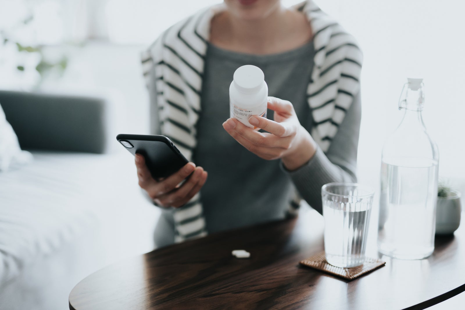 woman holding medicine bottle
