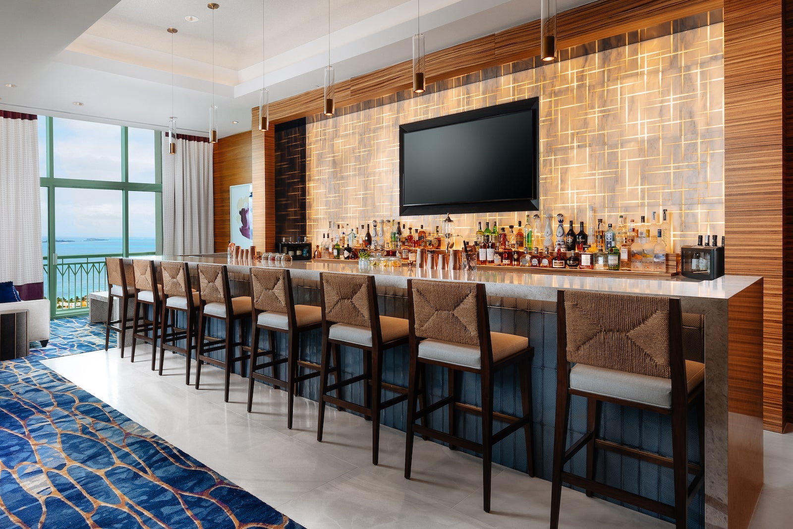 Hotel lounge bar with seats and bottles