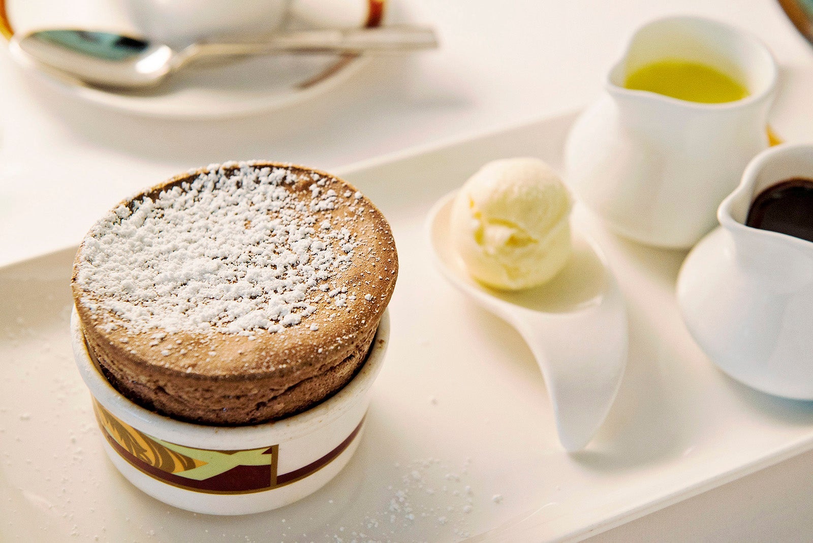 Chocolate souffle in ramekin on white plate