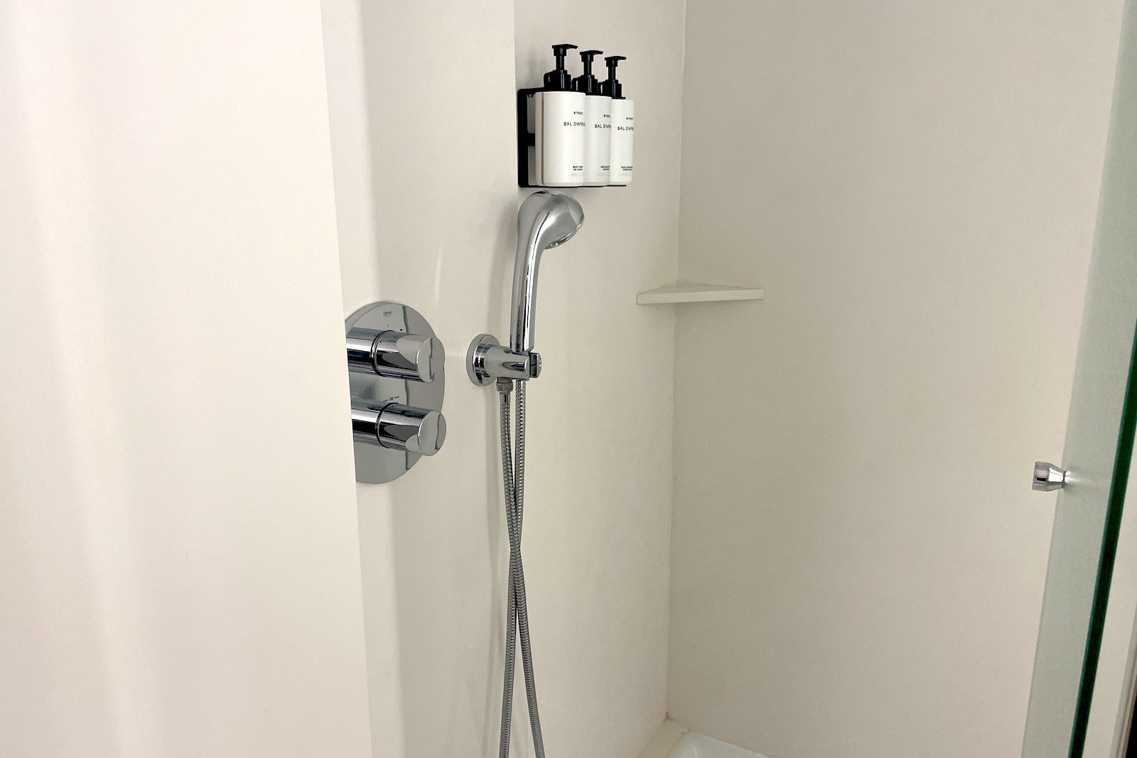 soaps and shower head in shower