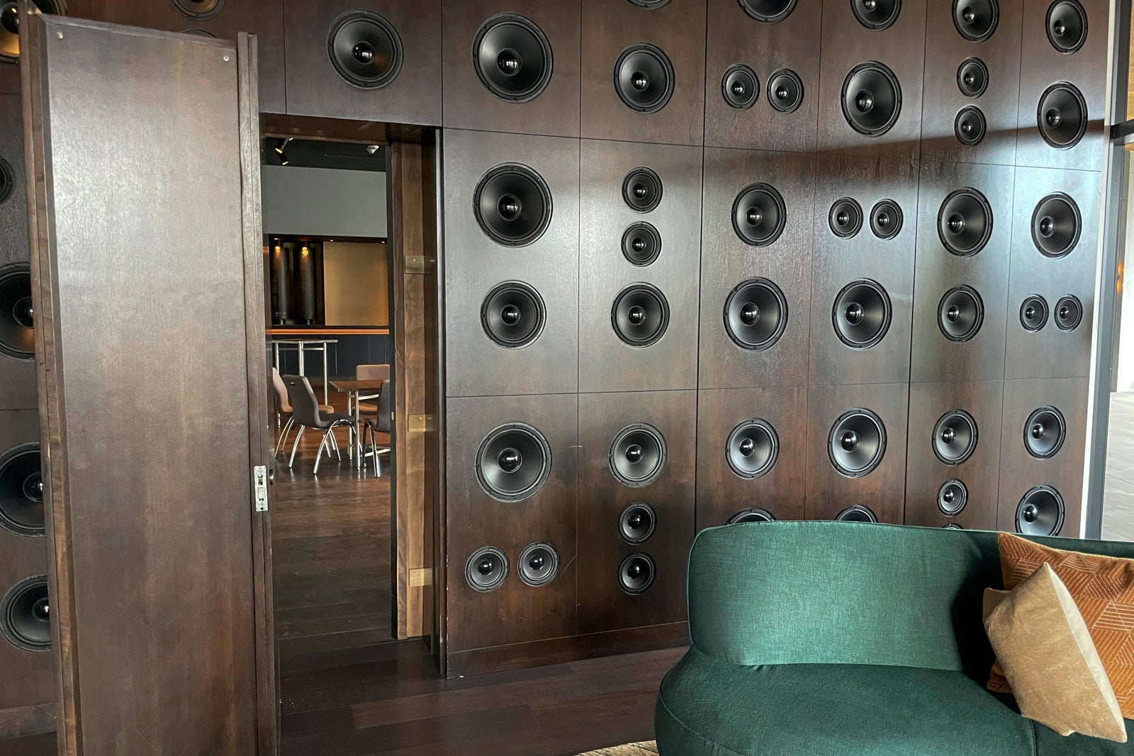 wall of speakers with velvet couch
