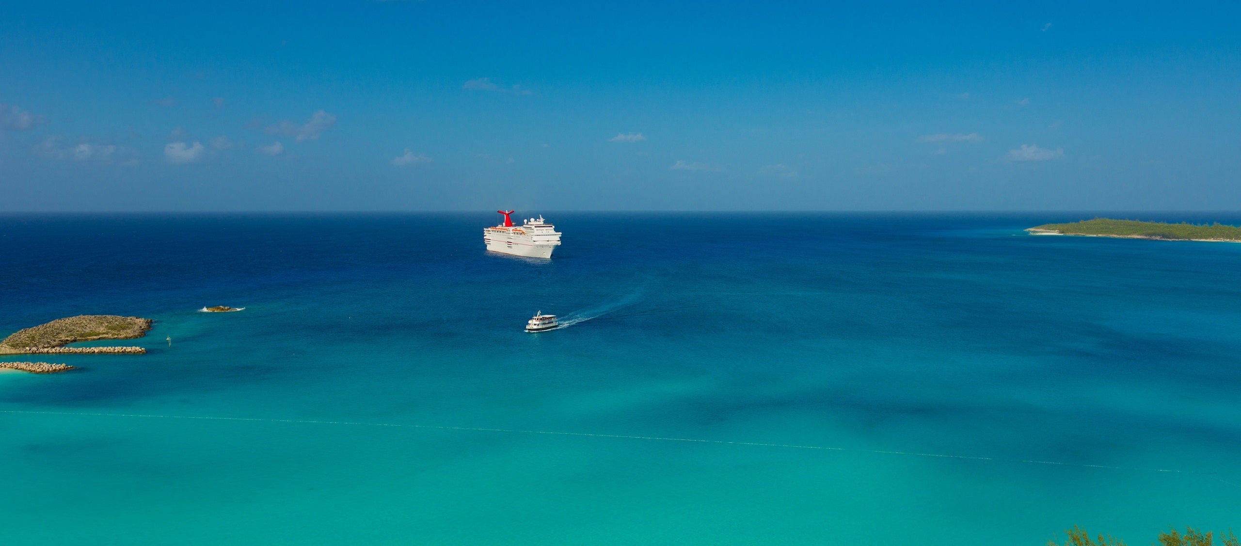 Carnival Elation anchored off of private island Half Moon Cay