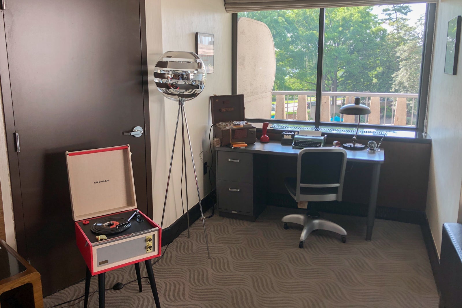 At the back end of the Scandal Room, you'll find an antique desk, plus a midcentury modern-inspired lamp and a replica record player.