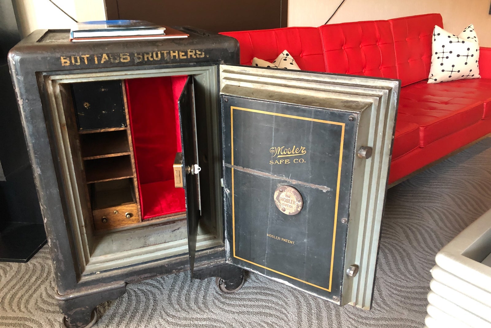 One of the Scandal Room's most unique features is the antique safe by the bright red sofa.