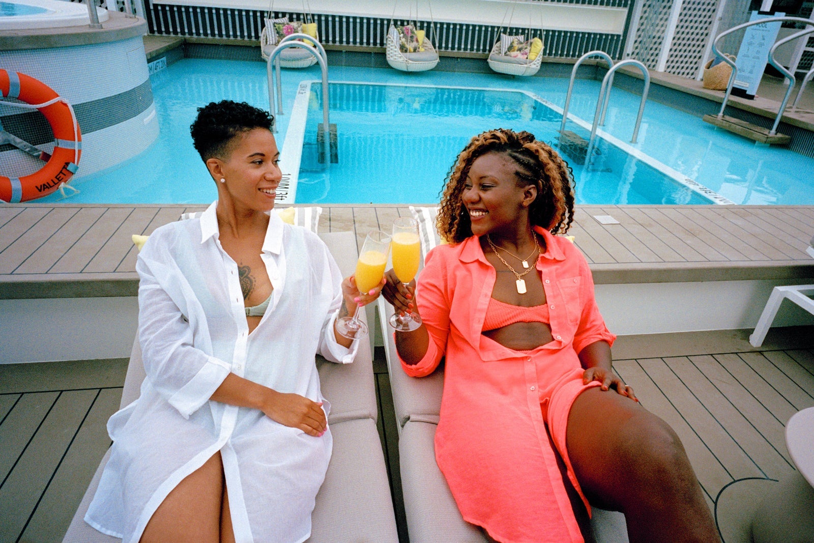 two women toasting on a cruise deck