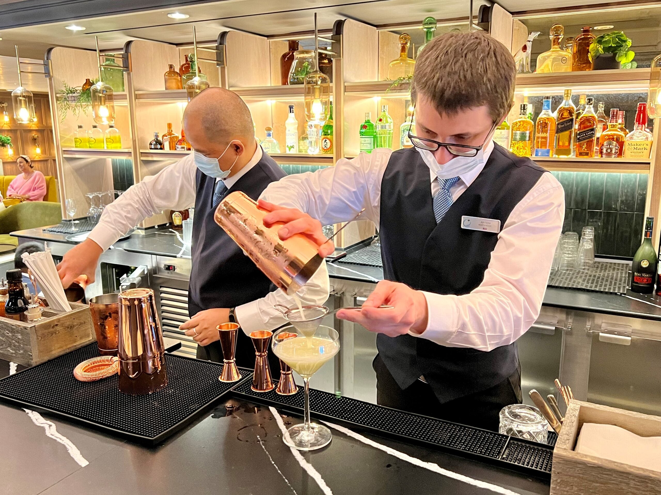 Bartenders mix drinks at the Atlas Bar