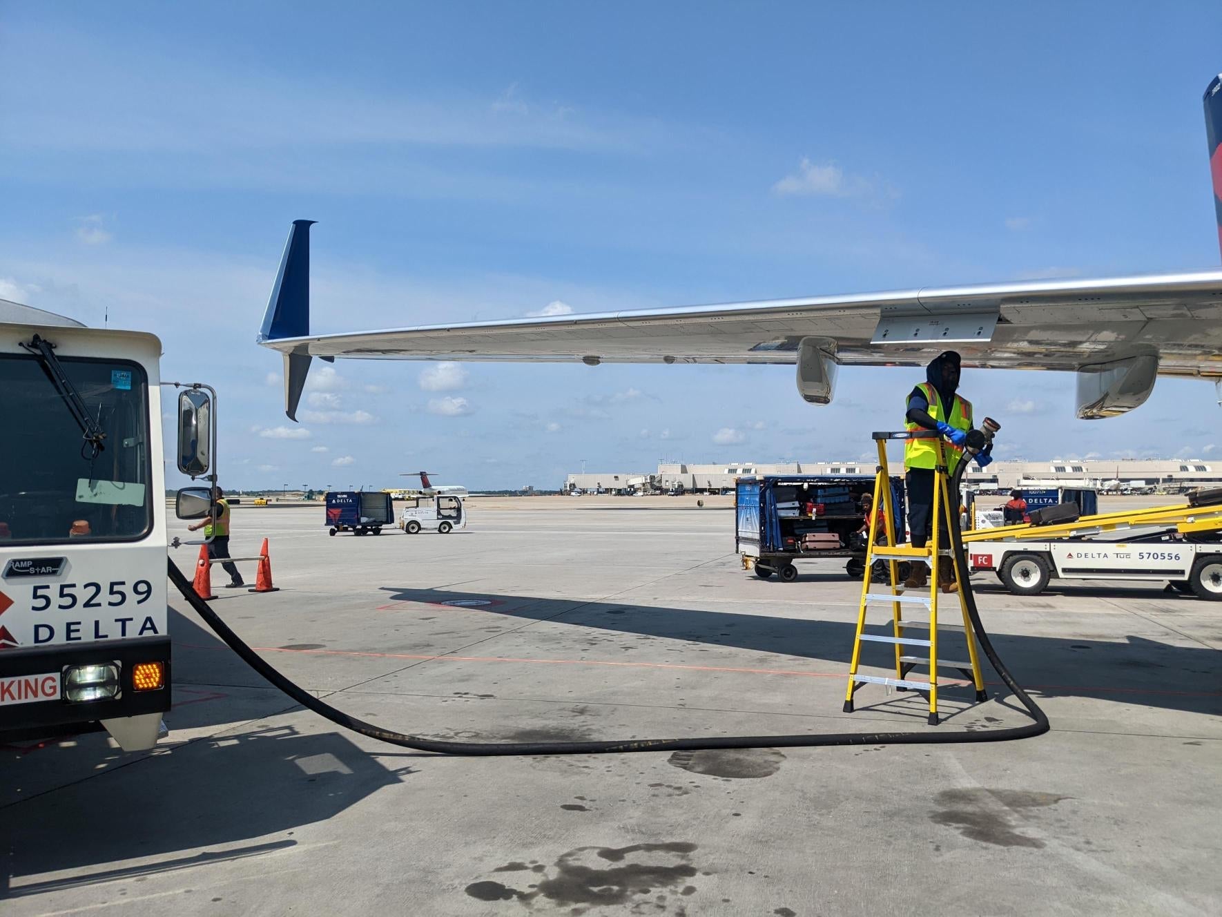Delta Air Line adding fuel to a plane.