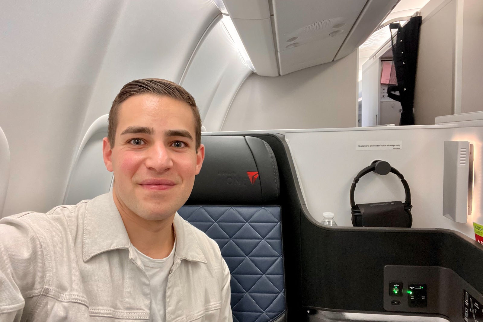 Zach in business class seat