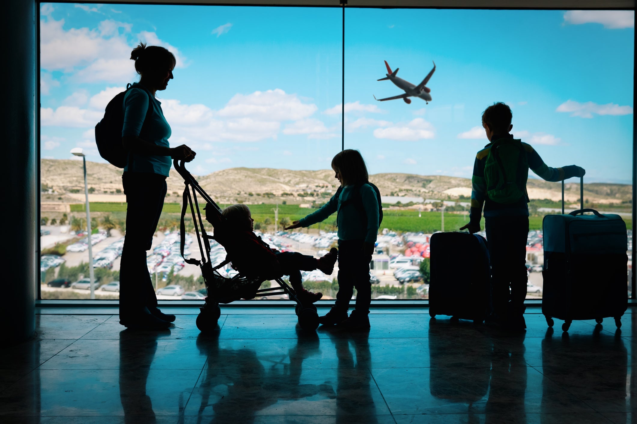 family at airport with luggage