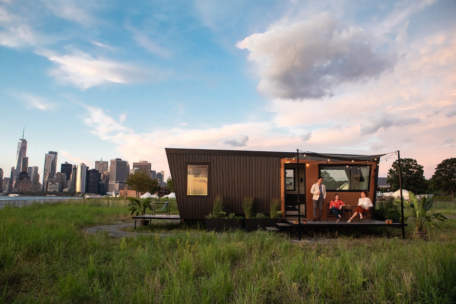 glamping cabin in field with NYC skyline in the background