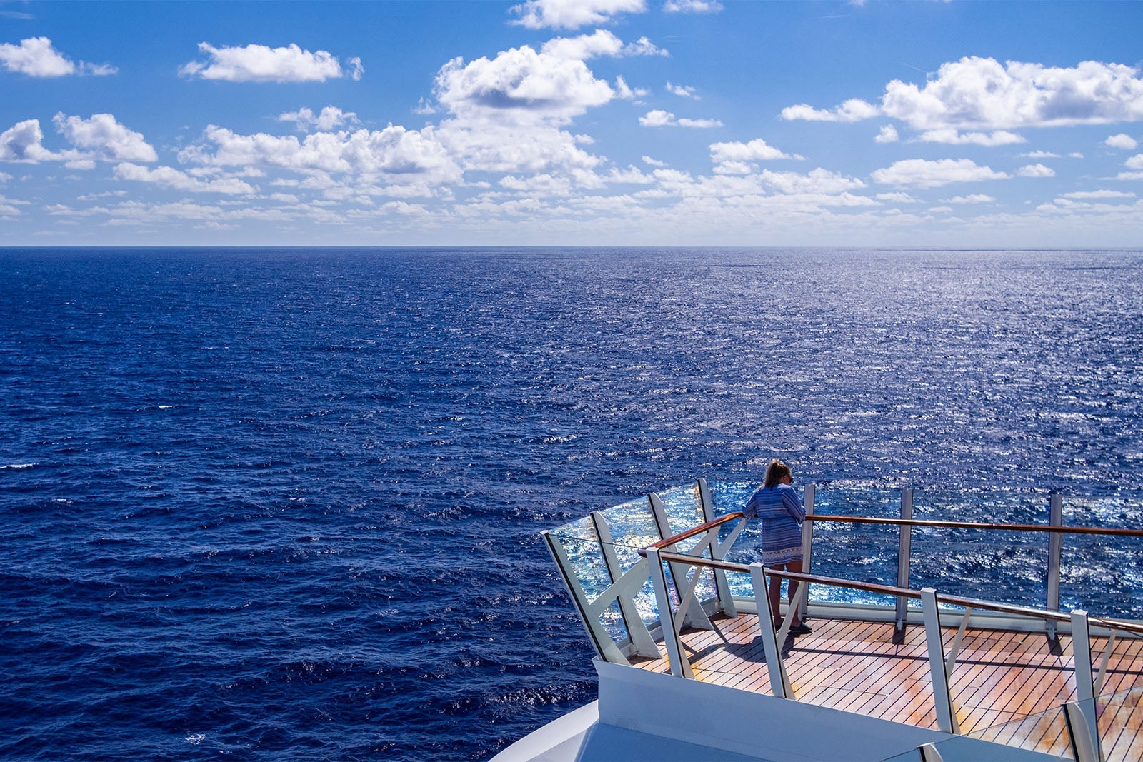 Woman Standing On The Deck Of A Cruise Ship In The Caribbean