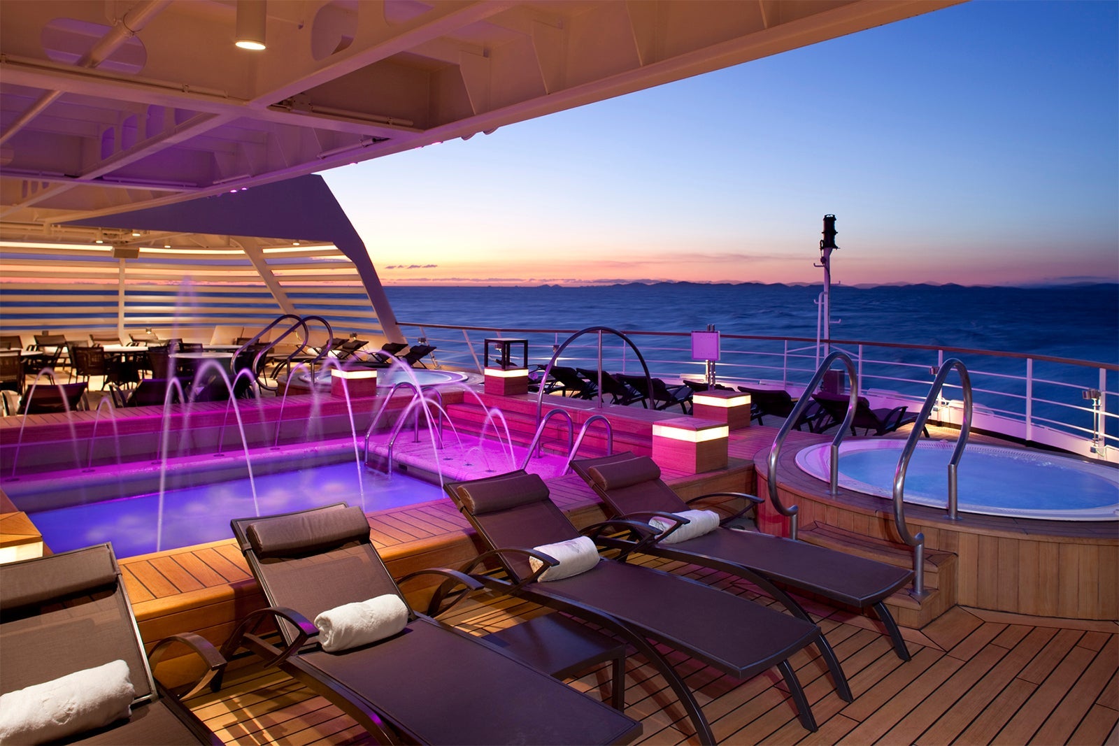 Cruise ship pool deck and hot tub at sunset