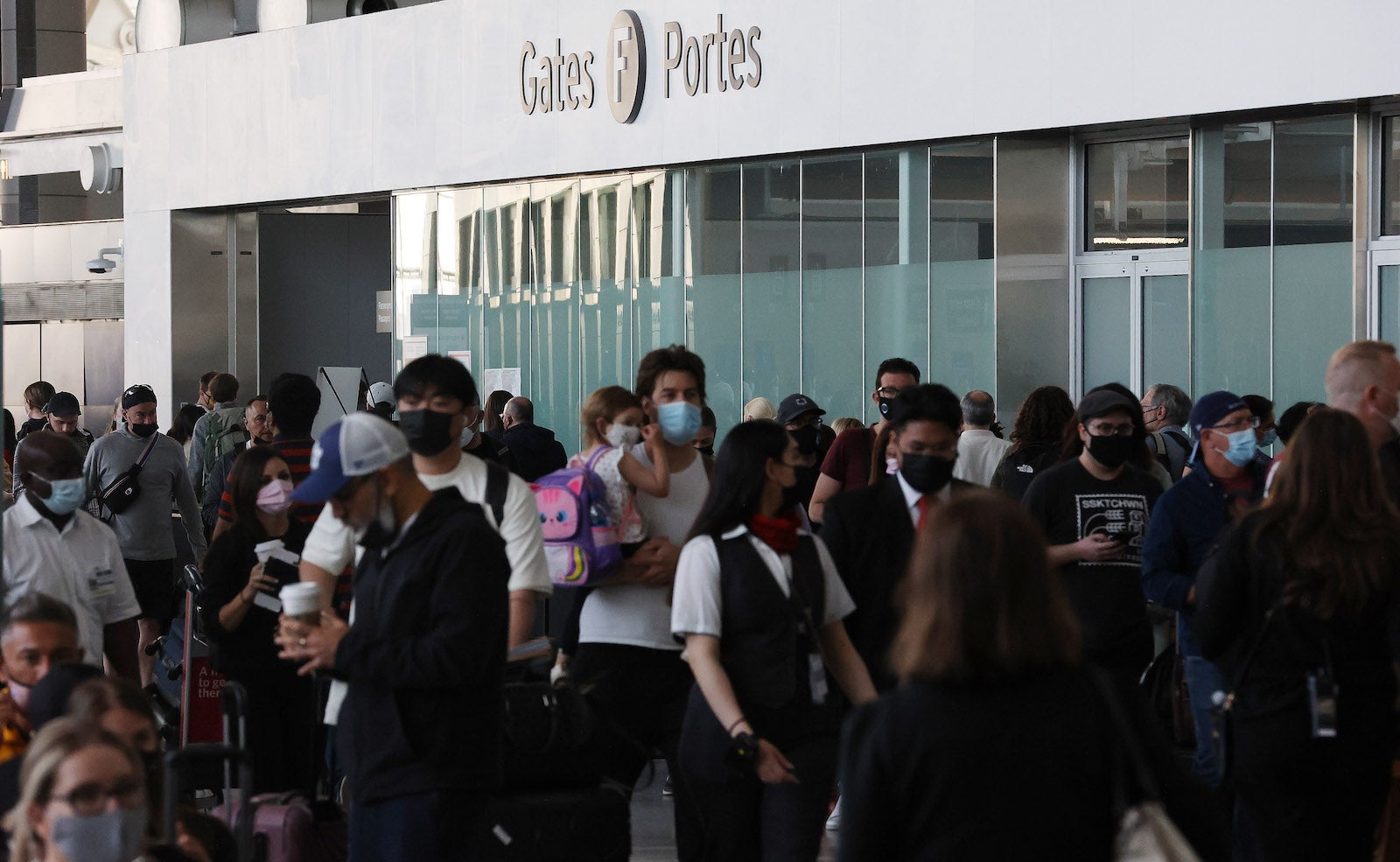 passengers wait in long line in Toronto