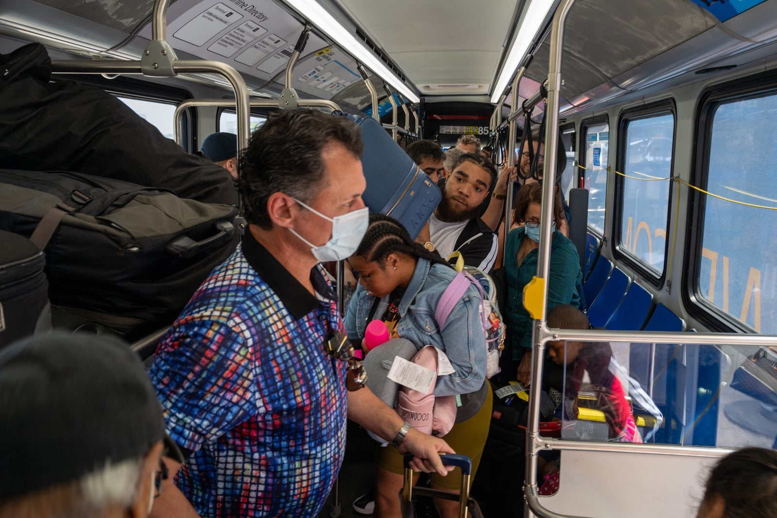 travelers on the shuttle at LGA