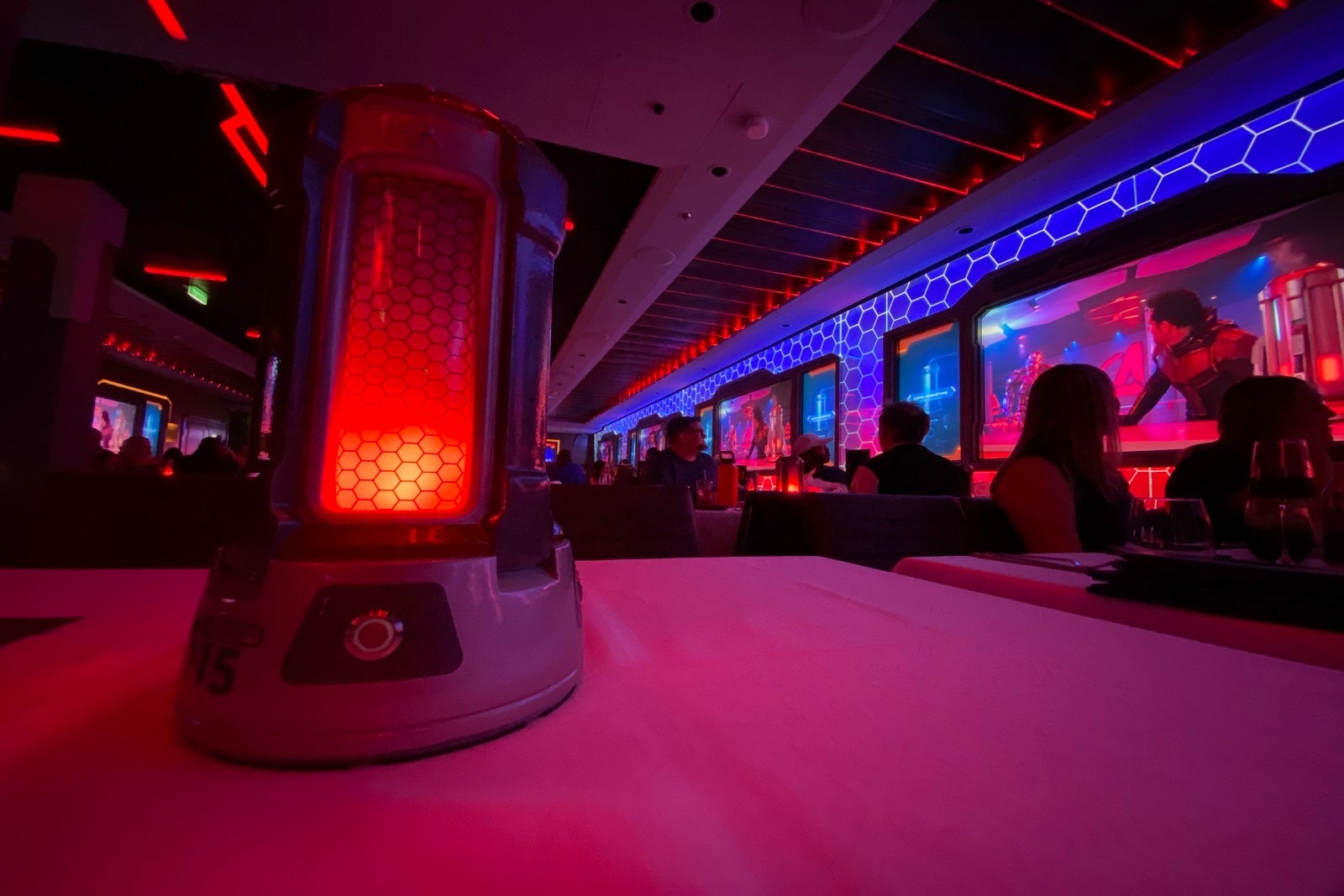 A low shot of a dining room table with purple and red lighting effects