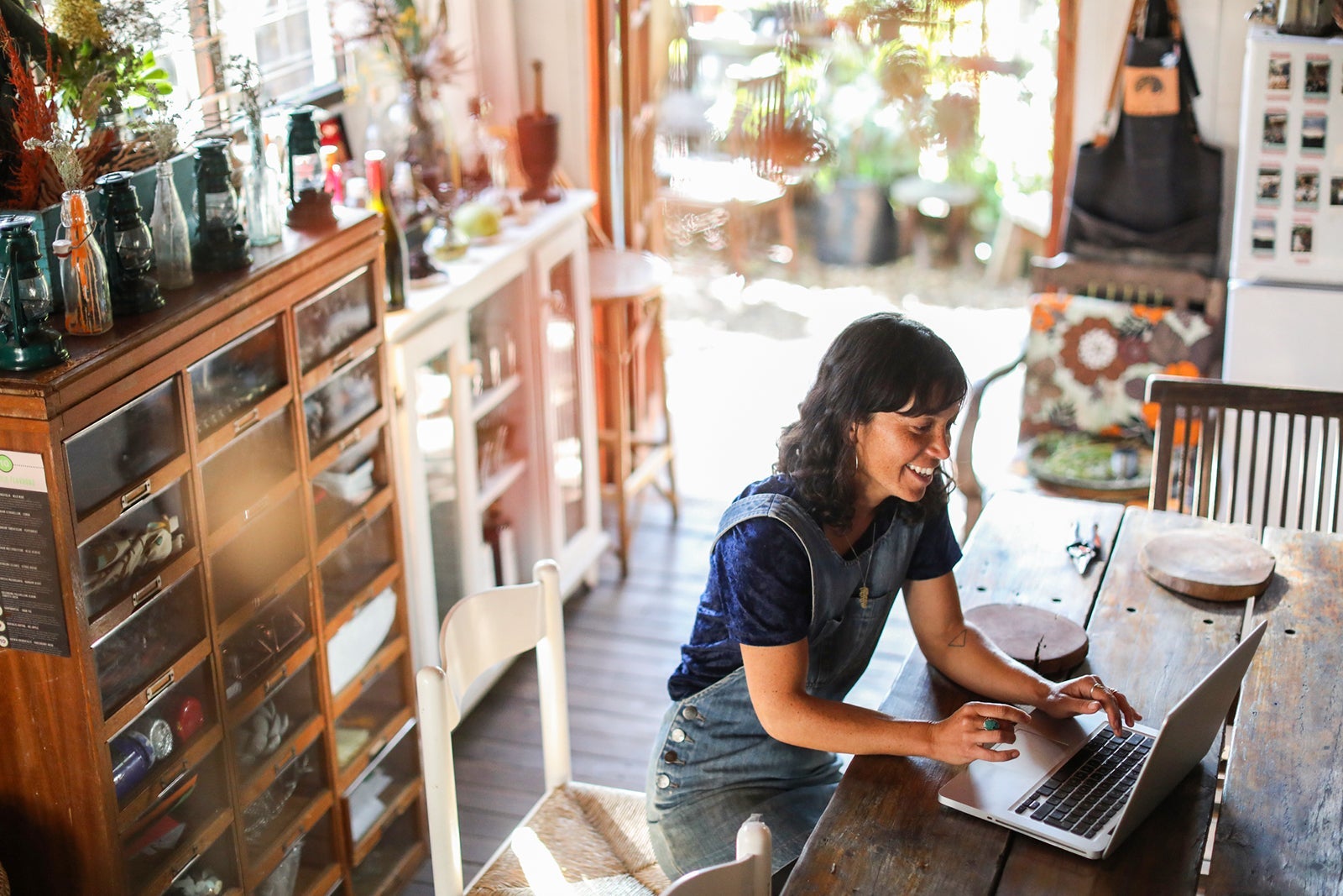 a Woman using her laptop in her kitchen at home.