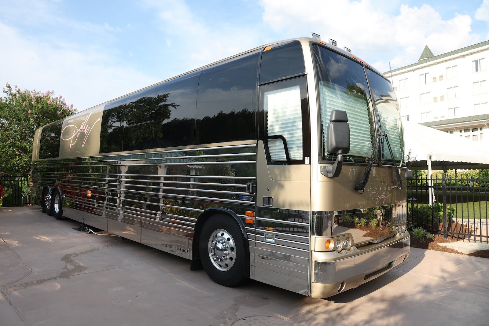tour bus with dolly parton's signature in pink on side