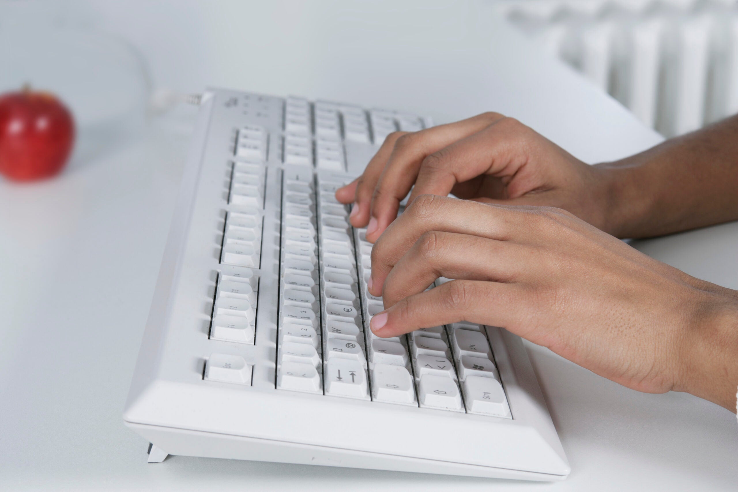 Woman typing on keyboard