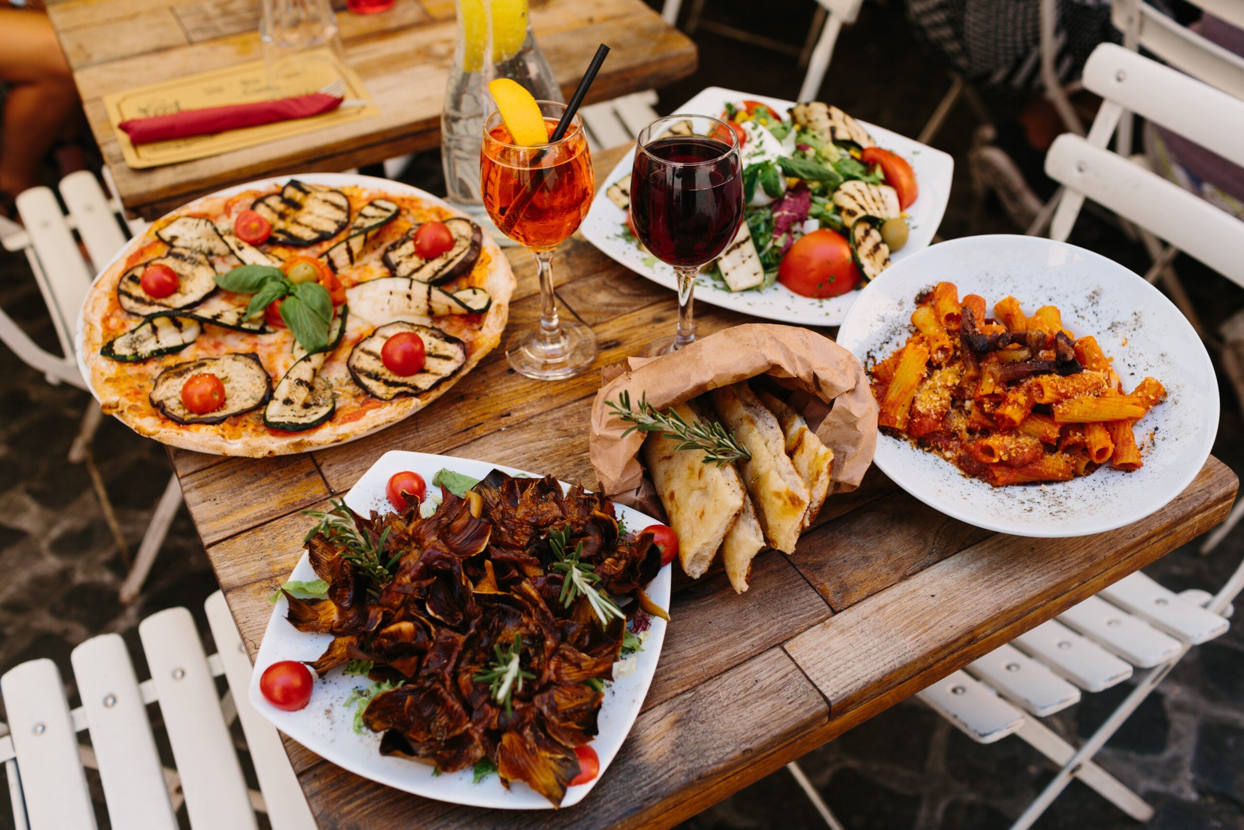 A display of fresh Italian disPizza, pasta, salad and bread.