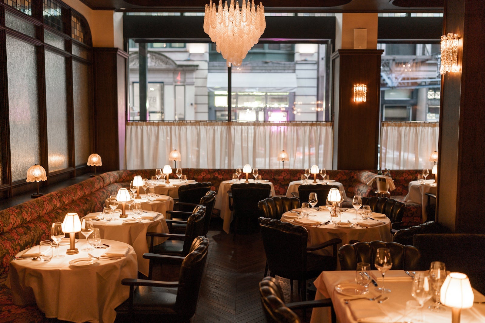 dark dining room with tables and chandelier