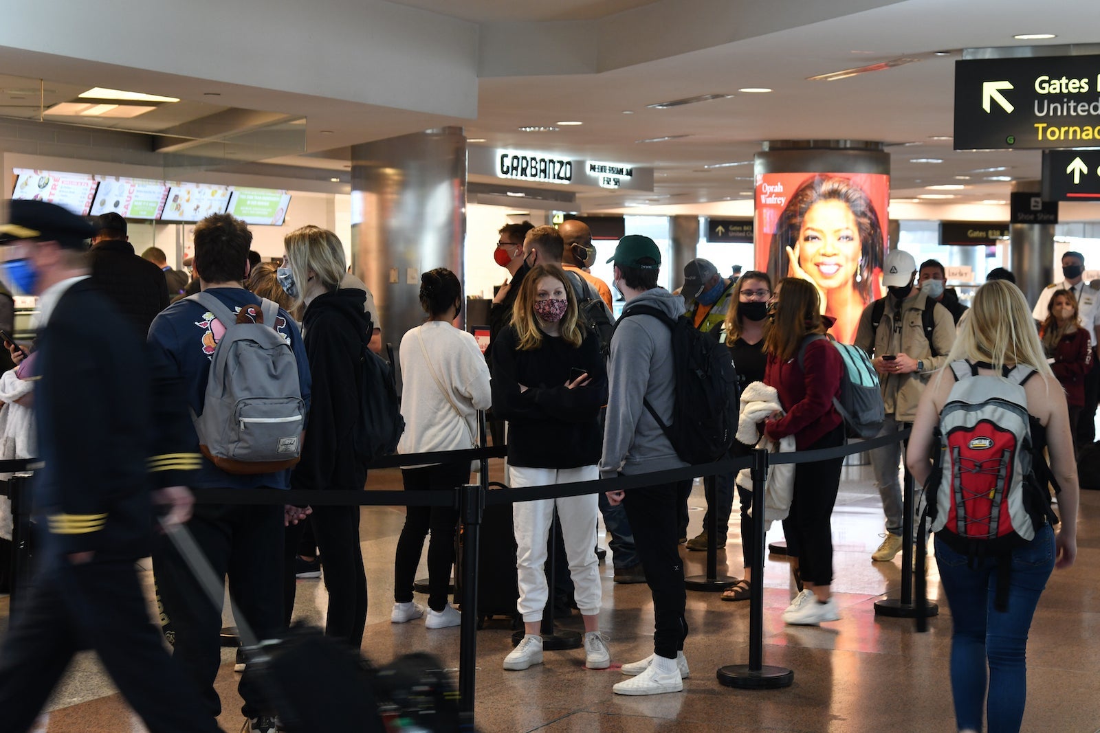 customers wait in line at Denver Airport in 2020