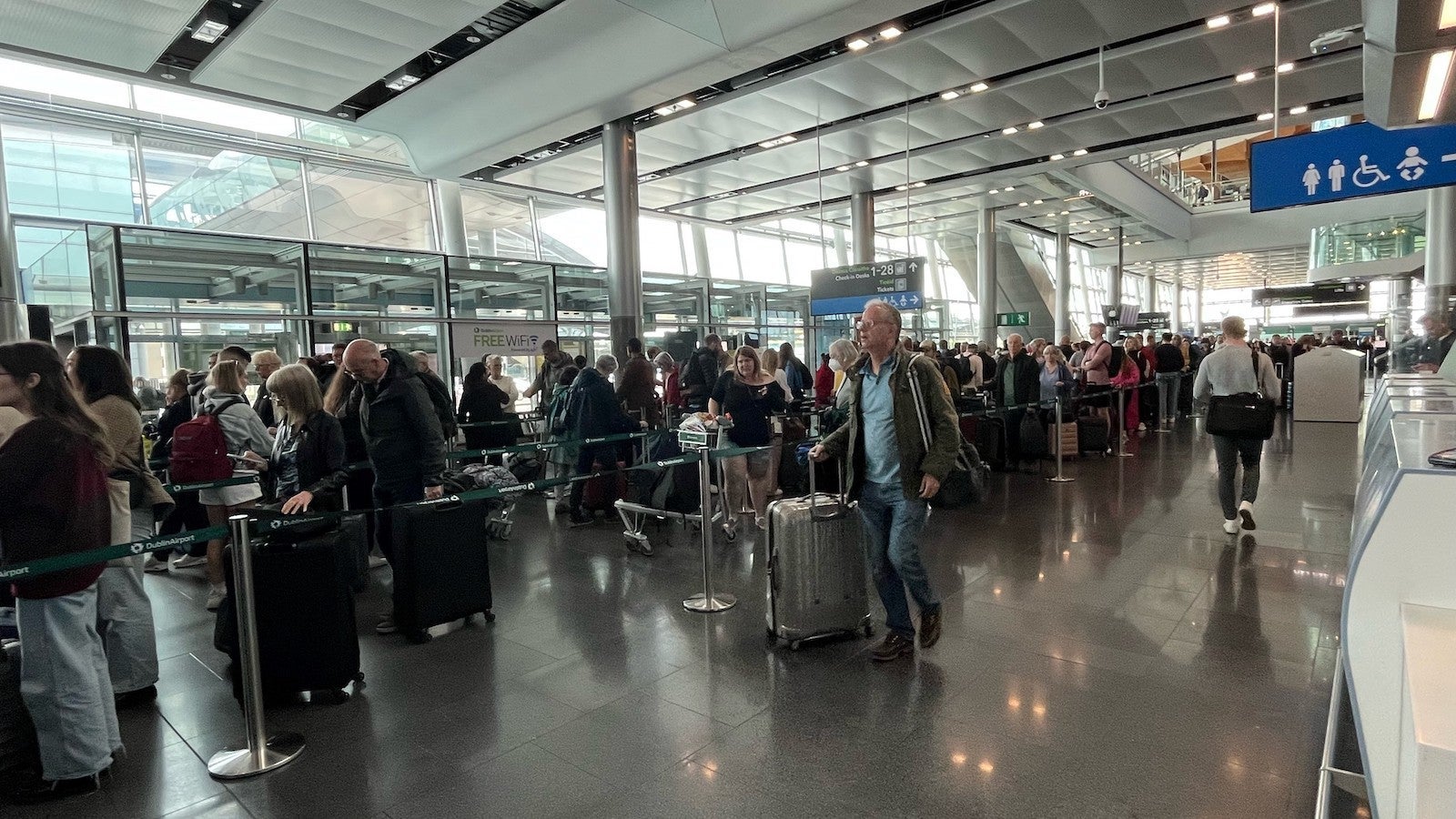 passengers wait in line at Dublin Airport