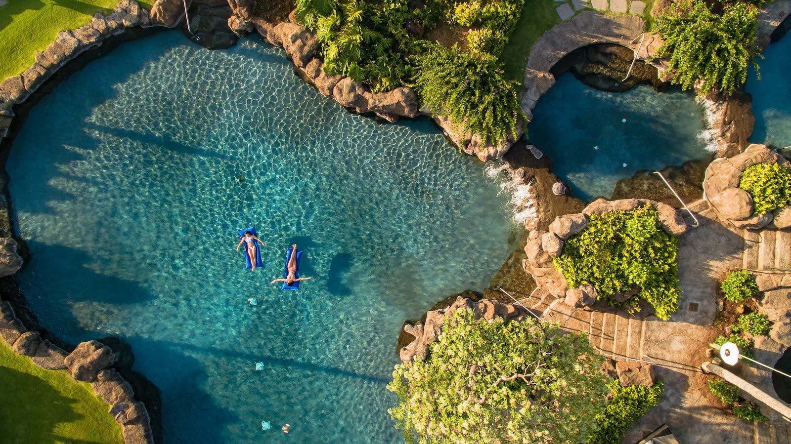 Two people floating in saltwater lagoon