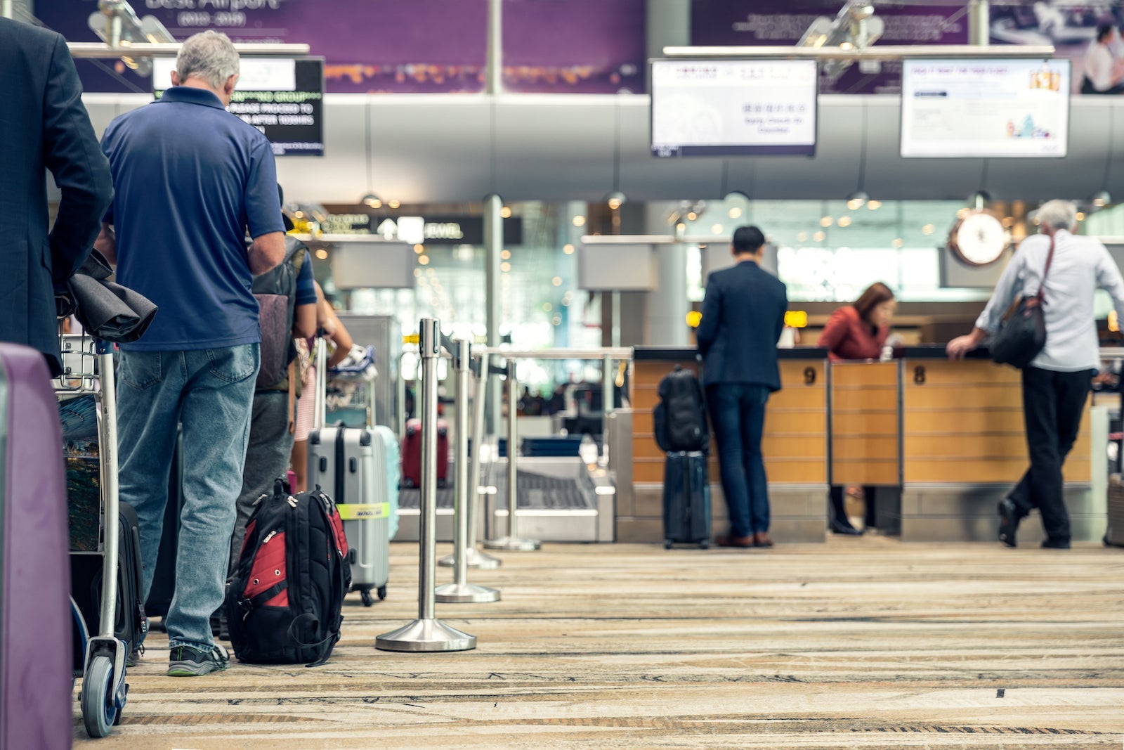 passengers in line to check luggage