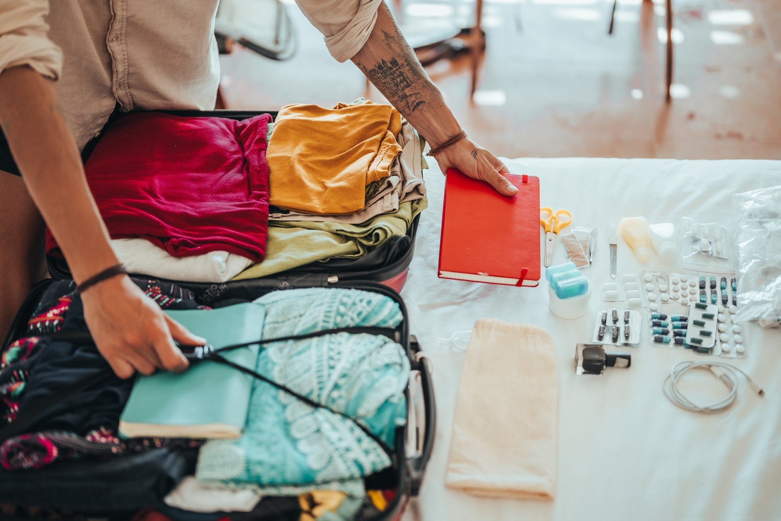 woman packs carry-on bag