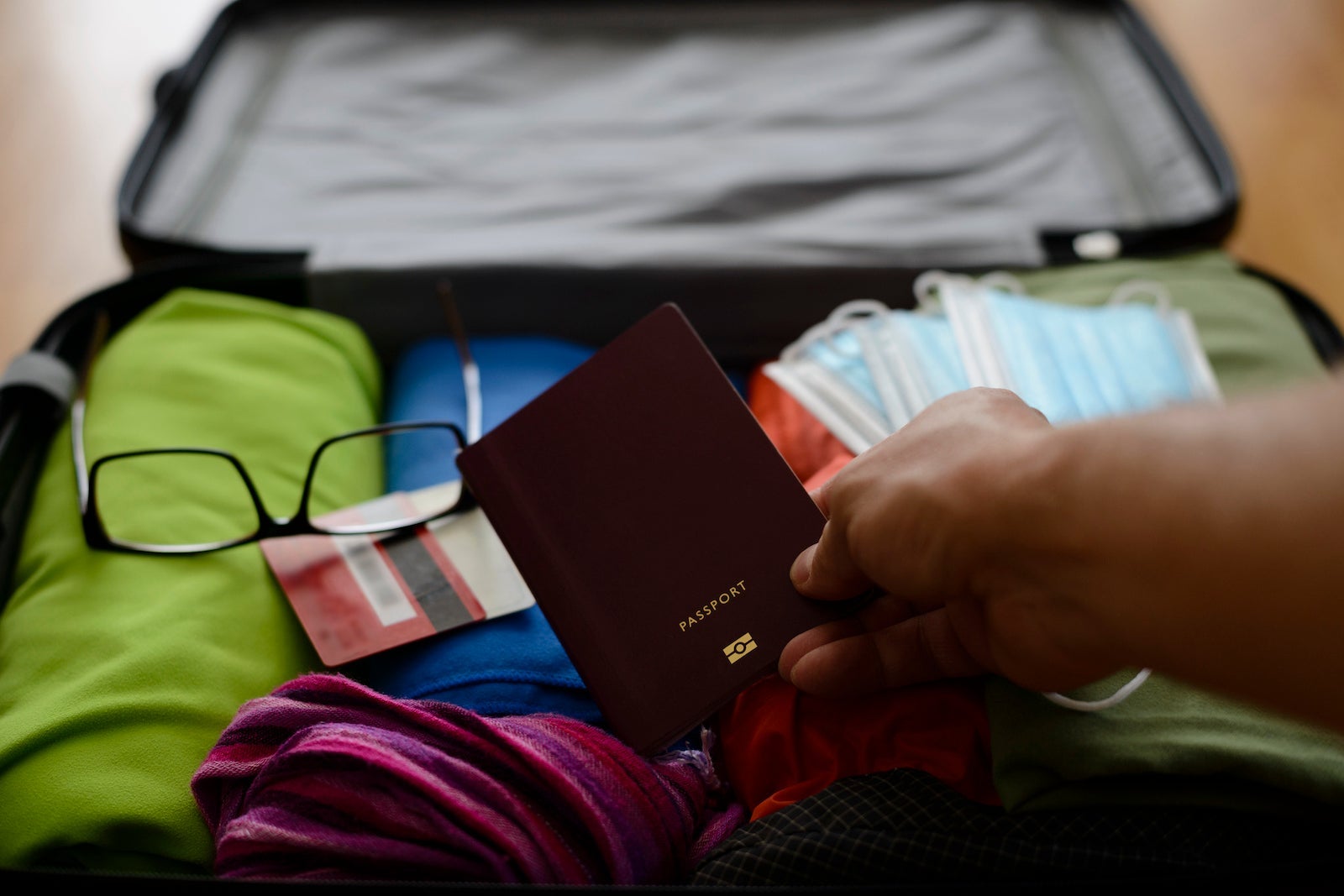 Man places passport in carry-on bag