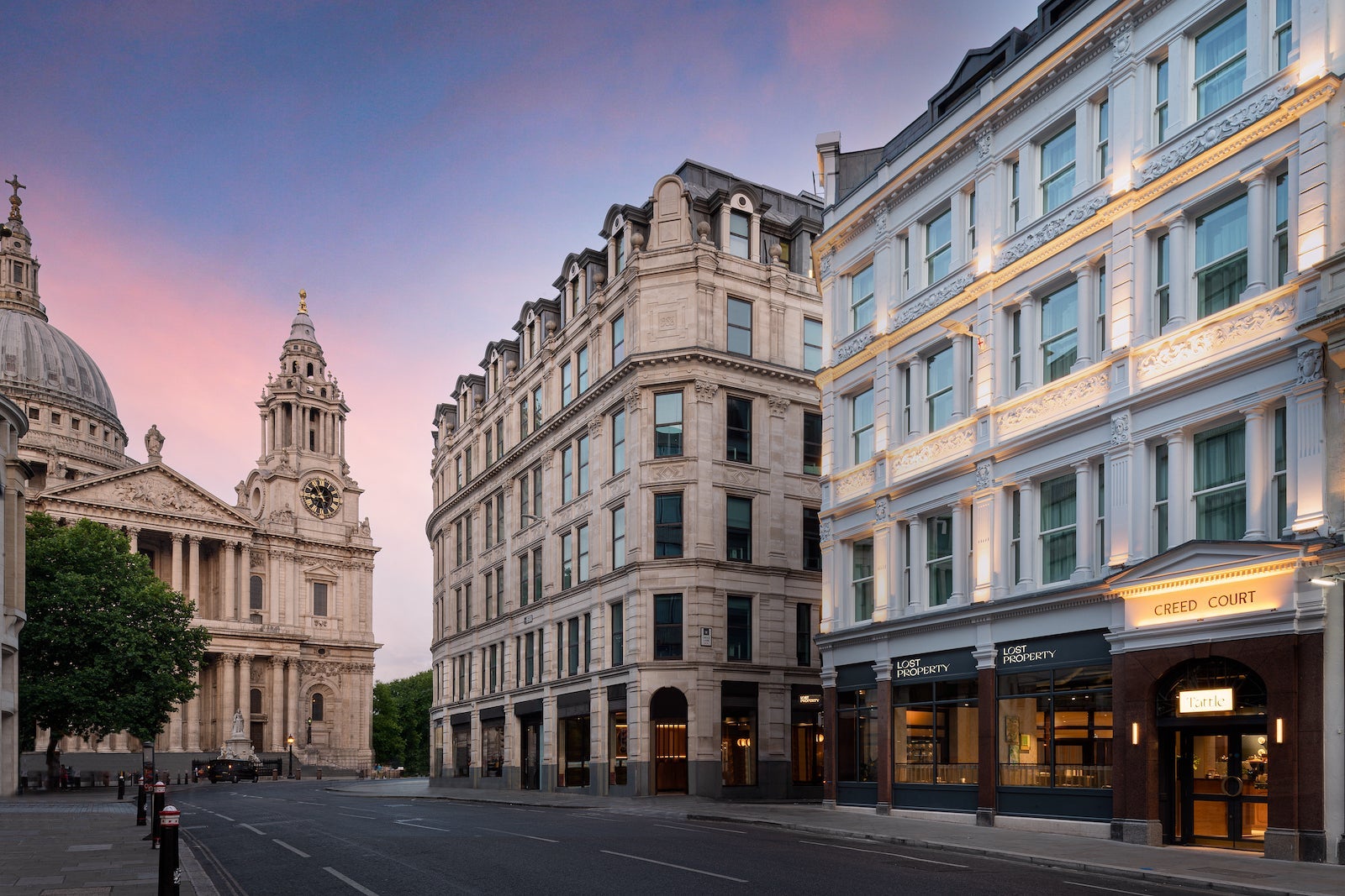 sunset over cathedral with domed arches, street with business