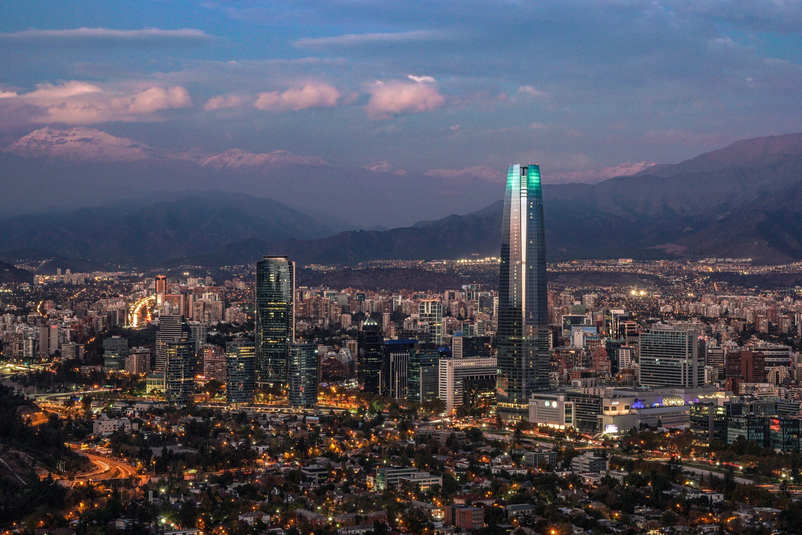 Night-time aerial view of the city including the Torre Santiago (tallest building in South America, 300m), from Cerro San Cristobal of Santiago, Chile