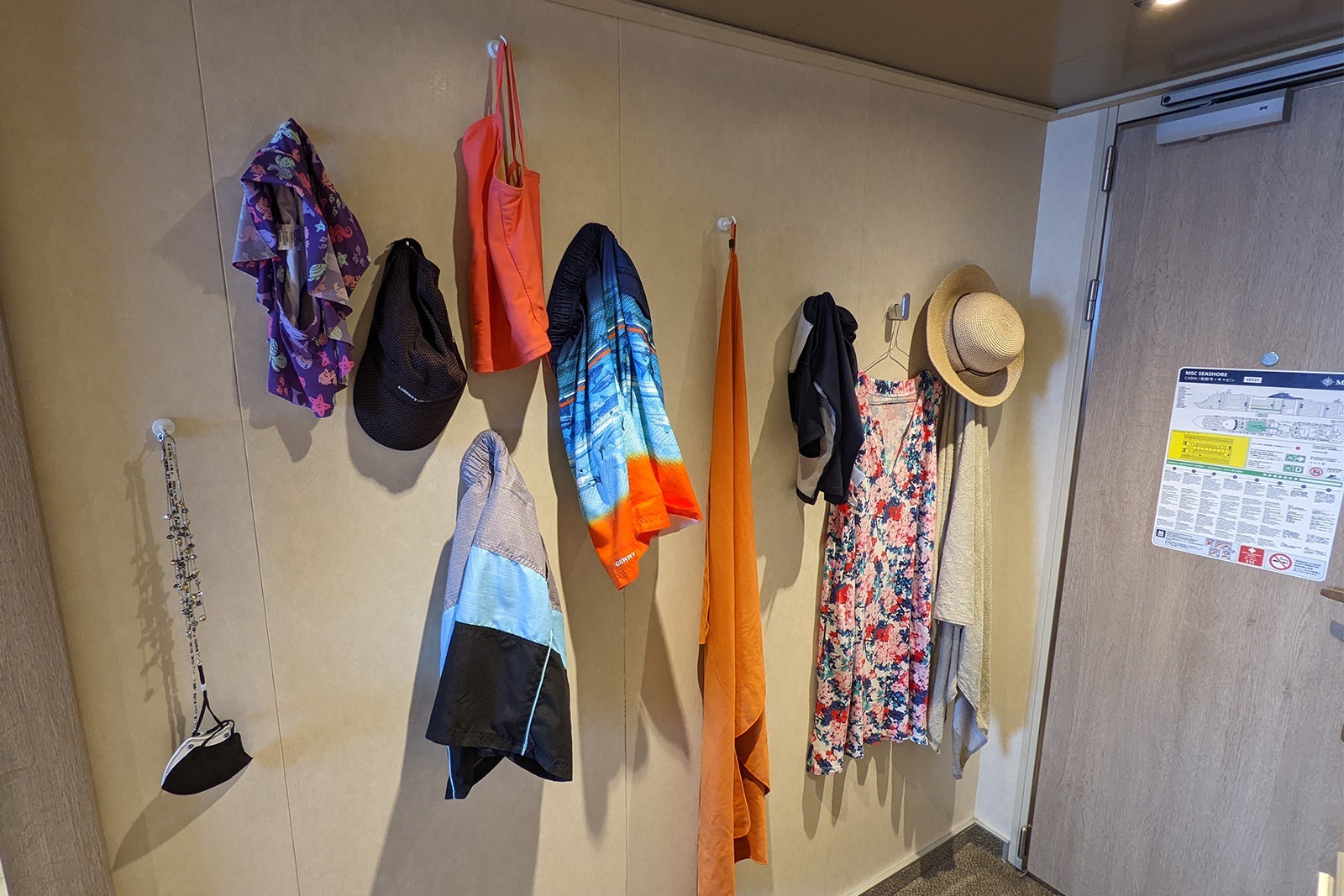 Clothes hanging on a wall in a cruise ship cabin