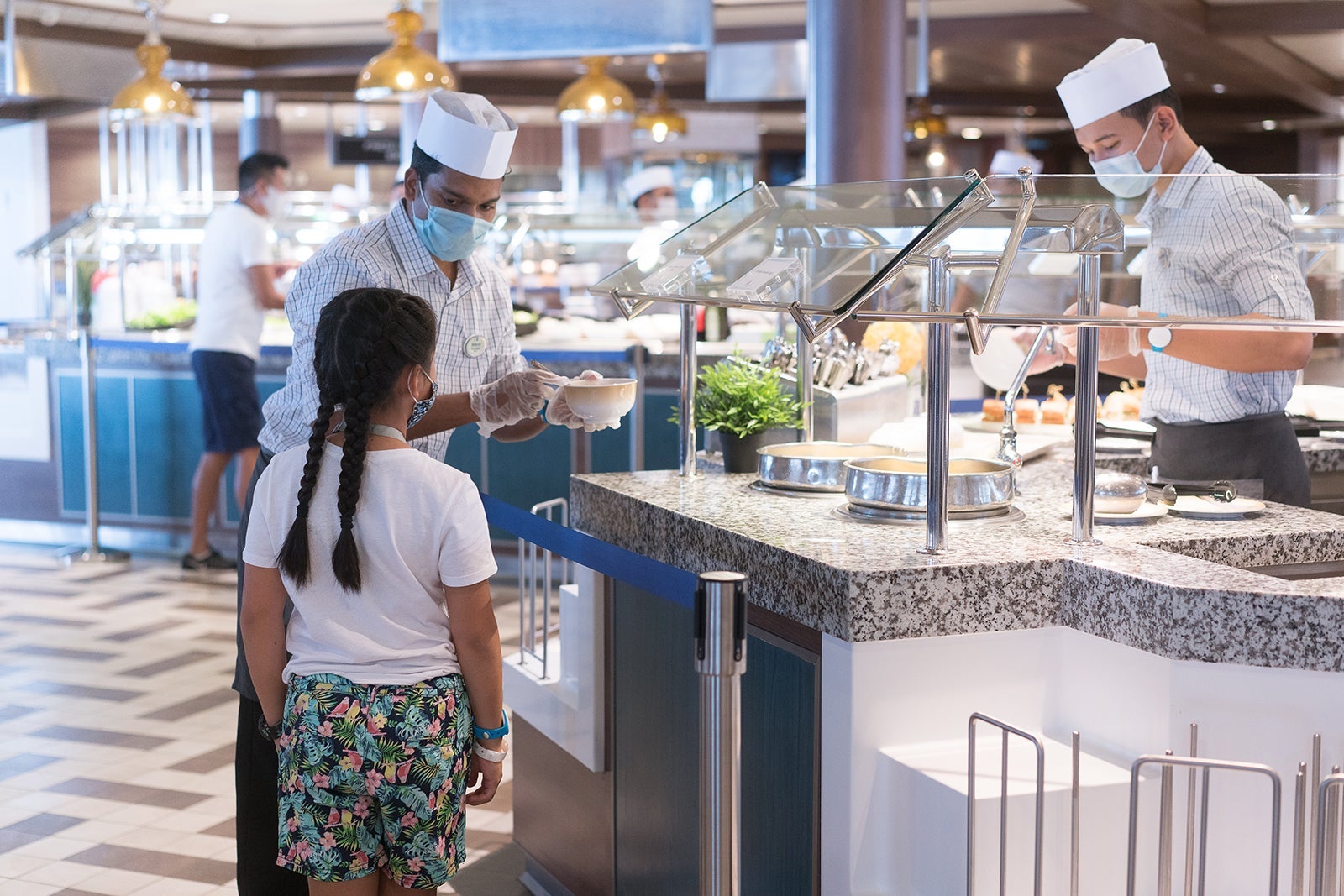 Crew member serving girl at Royal Caribbean cruise ship buffet
