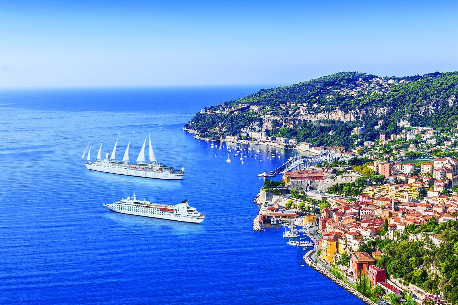 A Windstar yacht and sailing ship anchored off the coastline