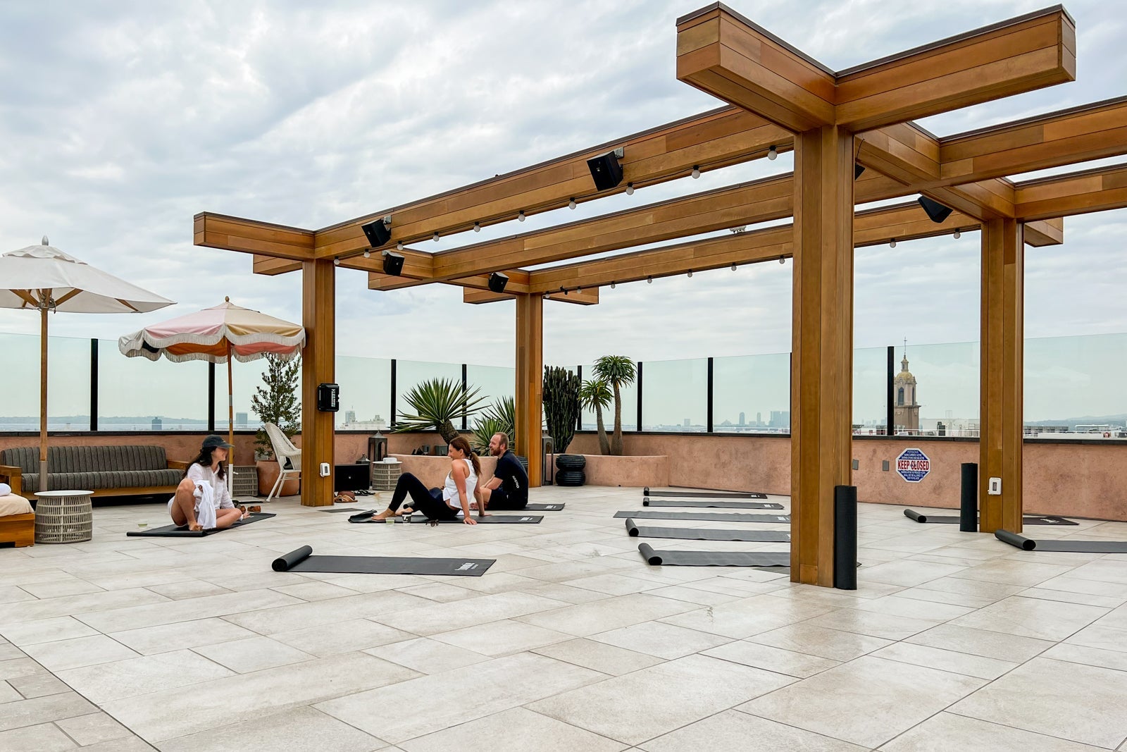 Rooftop pool area with yoga setup