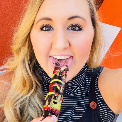 Photo of writer Carly Caramanna eating a churro