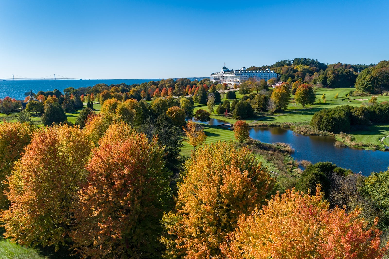 aerial photo of beautiful golf course with trees changing colors in fall