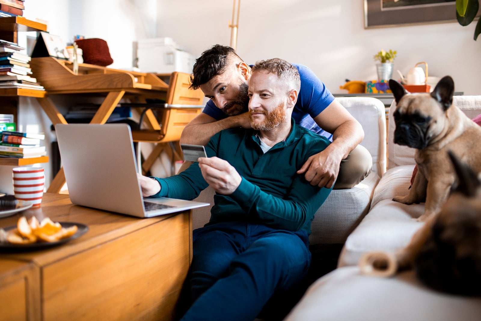 Male couple online shopping on their laptop