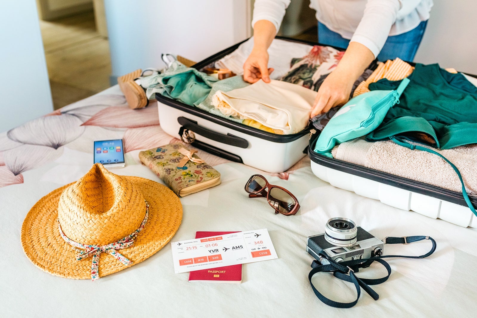 Woman packing a suitcase for a warm, sunny vacation