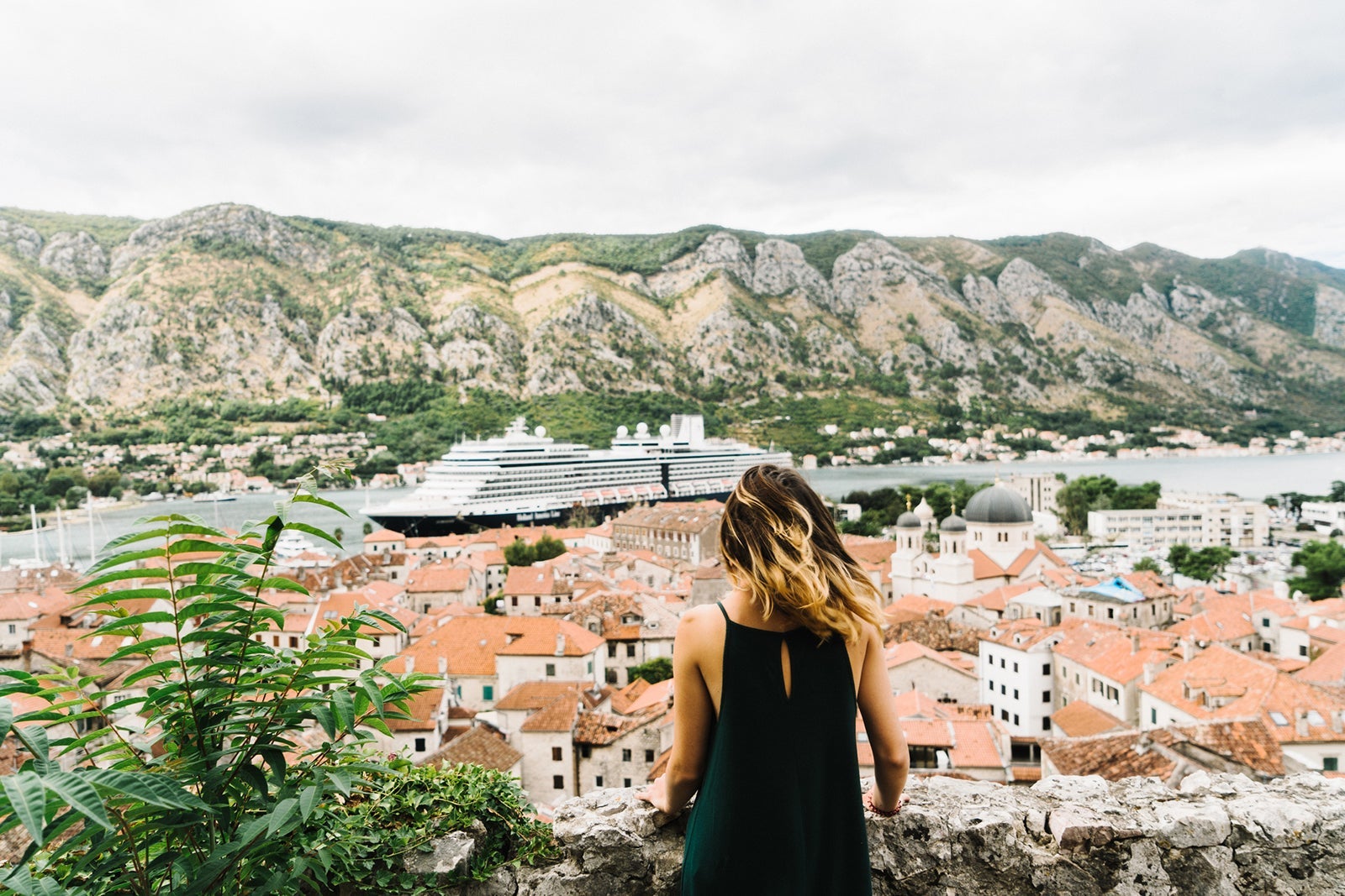 Women looking at cruise ship docked in Kotor, Montenegro