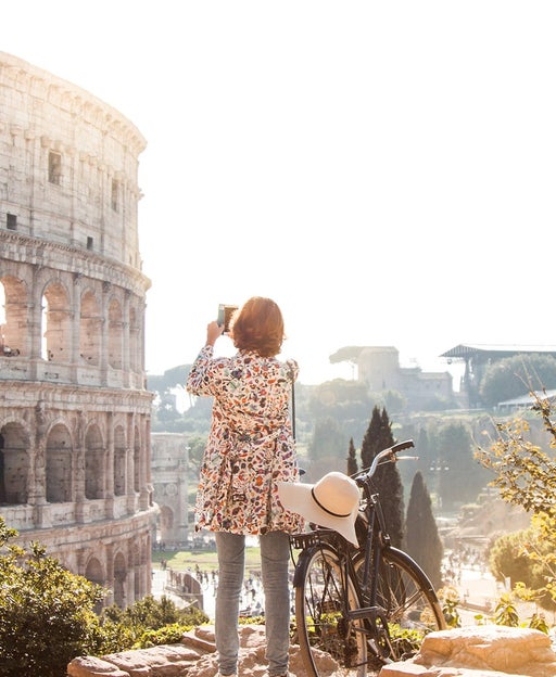 A woman sees the sights by bicycle in Rome
