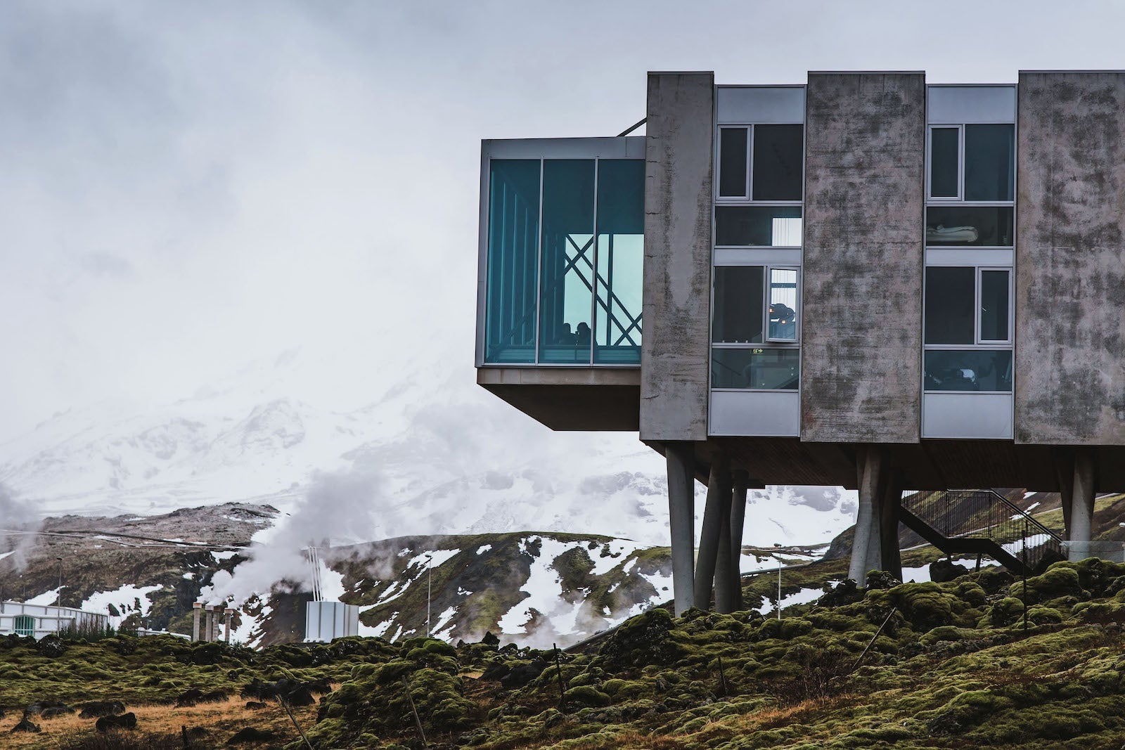 hotel on stilts near snow-covered mountains