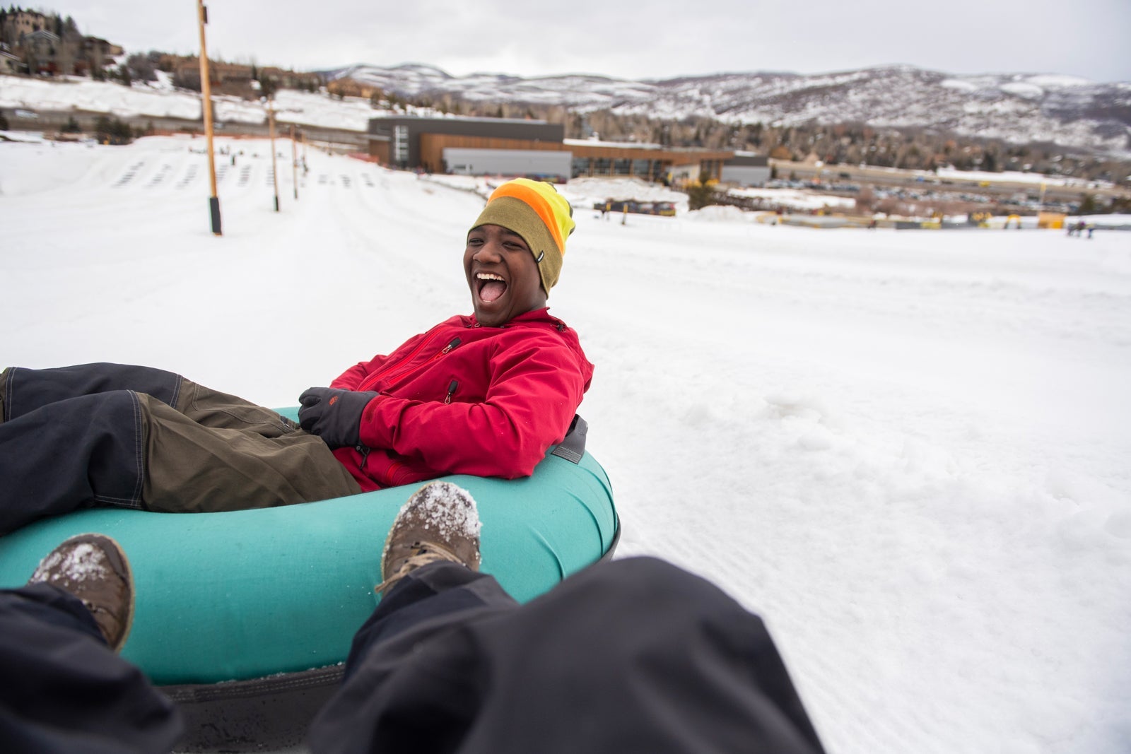 man snow tubing