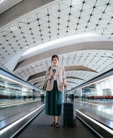 Woman in airport with suitcase